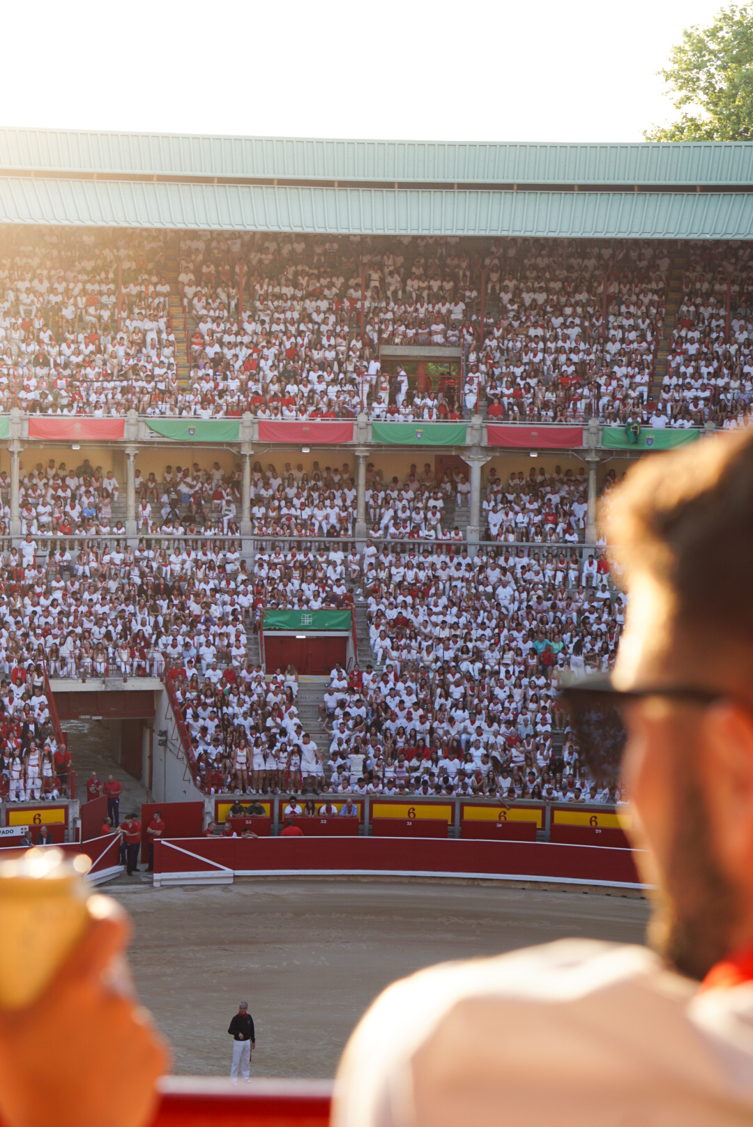 Crowd in white and red inside the Pamplona bullring