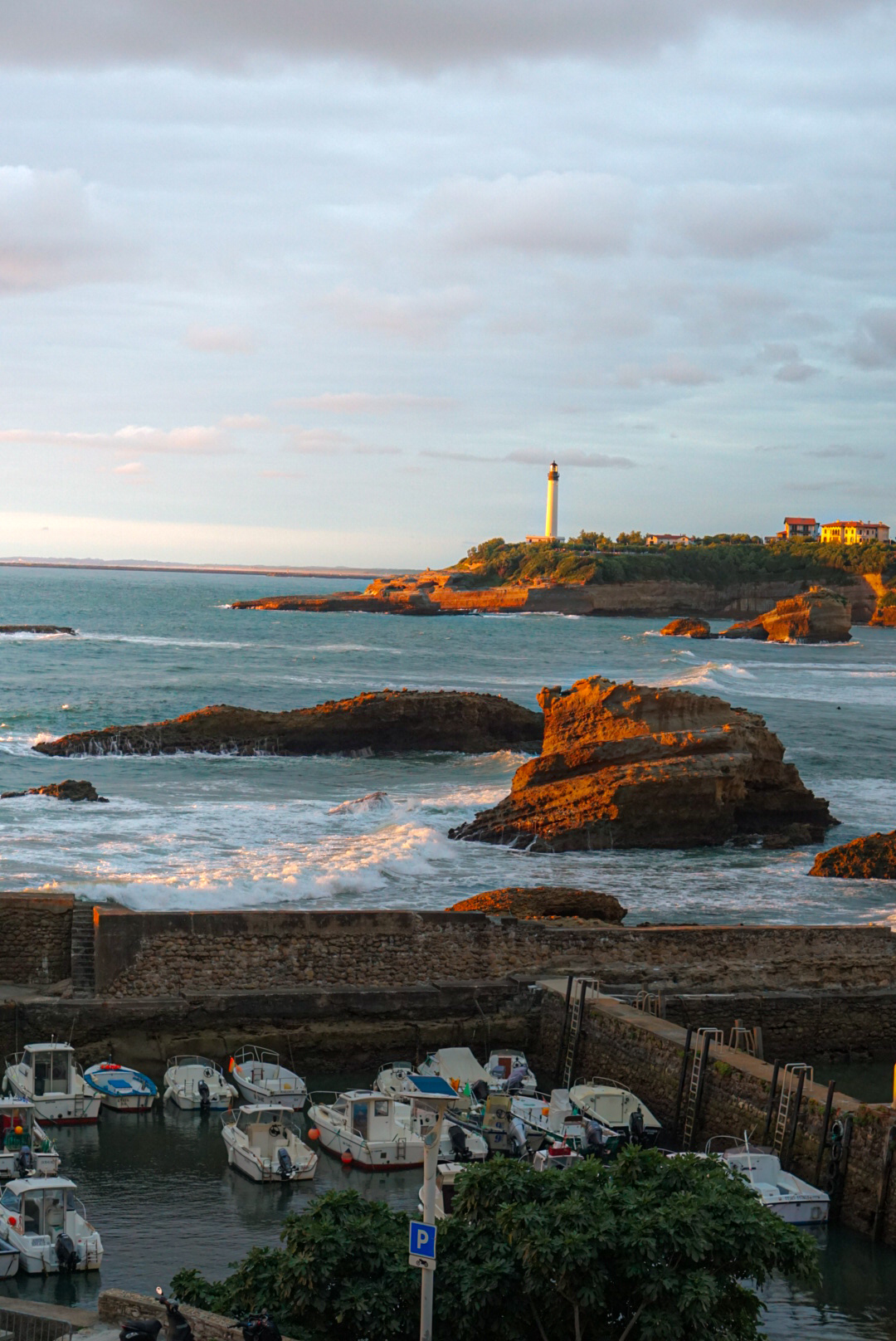 Lighthouse above the harbor at golden hour in Biarritz